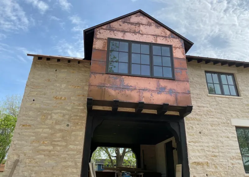 Copper metal panel facade on a stone building for Roof Repair in Mehlville