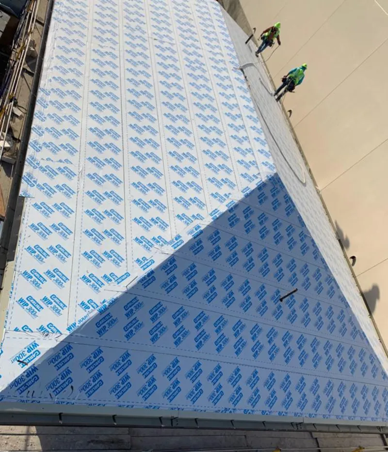 Professional roofers installing underlayment on a metal roof in Mehlville